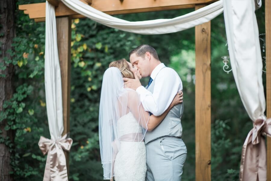 bride and groom kiss at outdoor wedding in Marietta, GA