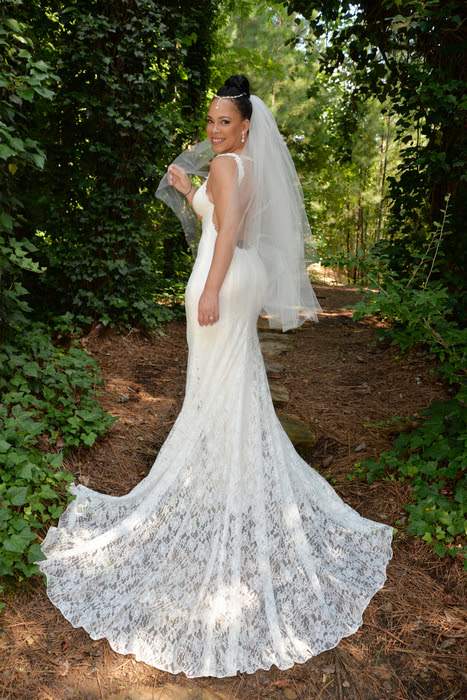 outdoor photo of bride in ivy walkway at gala